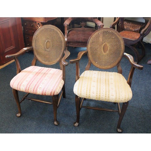 697 - A pair of Edwardian armchairs with oval bergere backs