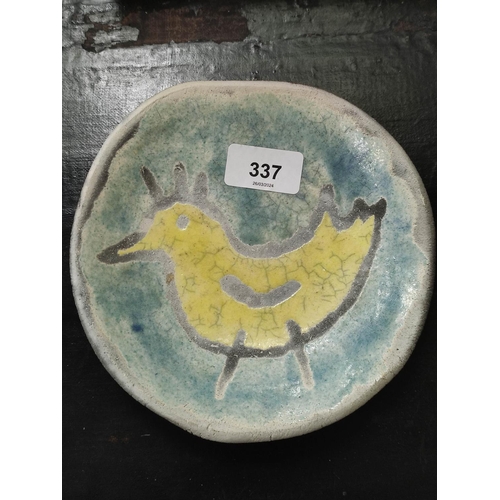 337 - Spanish art pottery shallow dish of primitive form, decorated with a yellow cockerel against a pale ... 