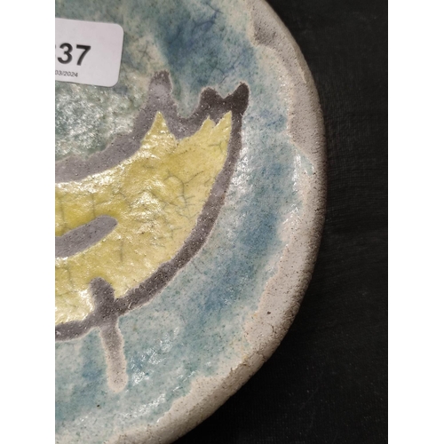 337 - Spanish art pottery shallow dish of primitive form, decorated with a yellow cockerel against a pale ... 