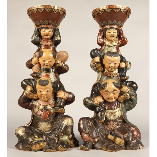 208 - Pair of Chinese pottery figure stands, each with a figure with two children on their shoulders suppo... 