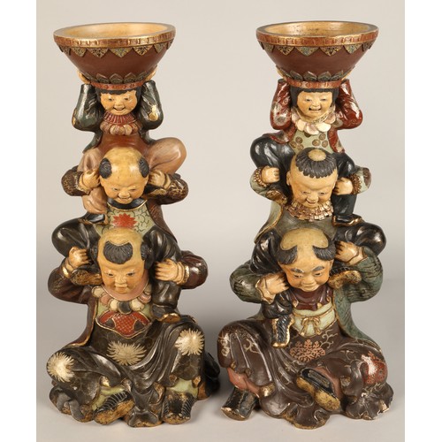 208 - Pair of Chinese pottery figure stands, each with a figure with two children on their shoulders suppo... 