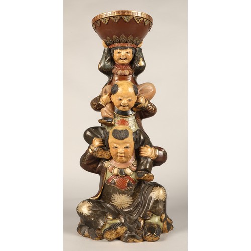 208 - Pair of Chinese pottery figure stands, each with a figure with two children on their shoulders suppo... 