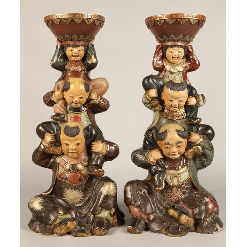 208 - Pair of Chinese pottery figure stands, each with a figure with two children on their shoulders suppo... 