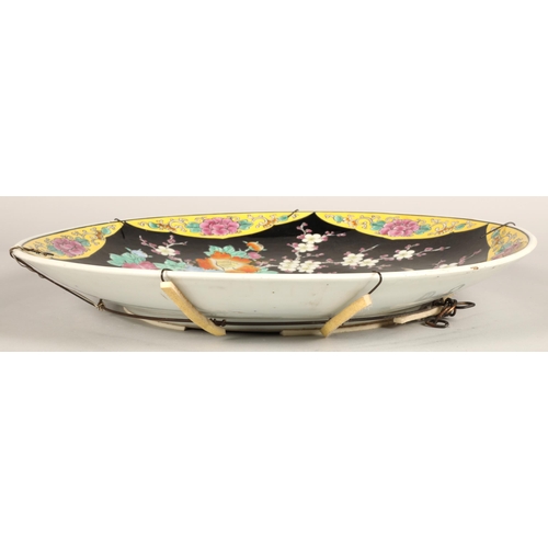 214 - Japanese porcelain charger, black ground with bird and foliate decoration, 46cm diameter.