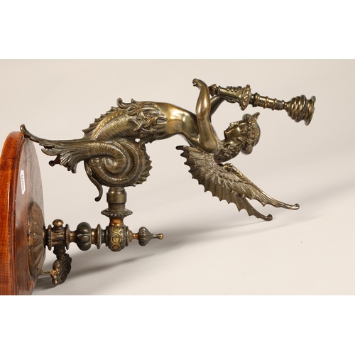 244 - Pair wall mounted candleholders in the form of a winged creature.