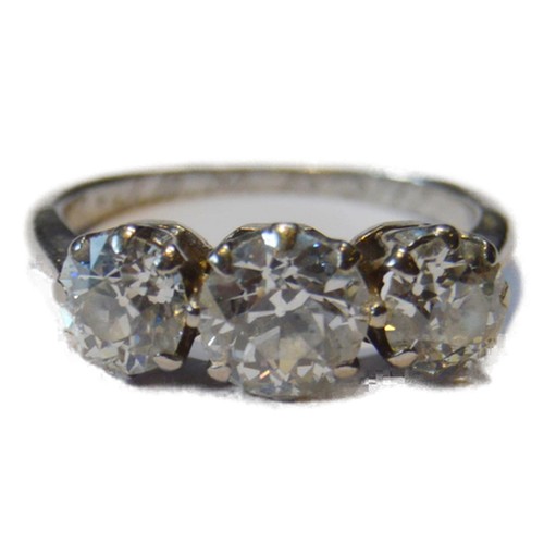 Diamond three-stone ring set with three old brilliant-cut graduated stones in a claw setting, approximately 1.8ct in total, on white metal shank, probably platinum, size K.