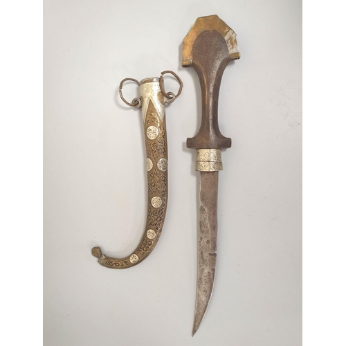 348 - Arabic Jambiya dagger of elongated form with white metal and brass mounts and wooden handle. 