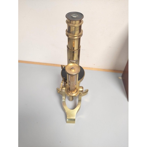 463 - An unattributed mid Victorian monocular petrological microscope of gilt brass construction, concave ... 