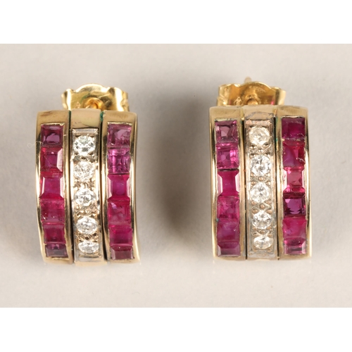 104 - Pair of ladies 18ct yellow gold Ruby and Diamond earrings, central row of five diamonds flanked by a... 