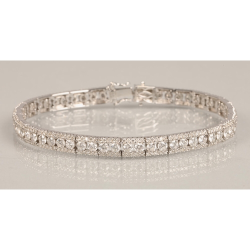 73 - Ladies 18k white gold diamond tennis bracelet, 56 small brilliant cut diamonds with a row of smaller... 