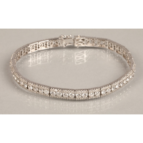 73 - Ladies 18k white gold diamond tennis bracelet, 56 small brilliant cut diamonds with a row of smaller... 