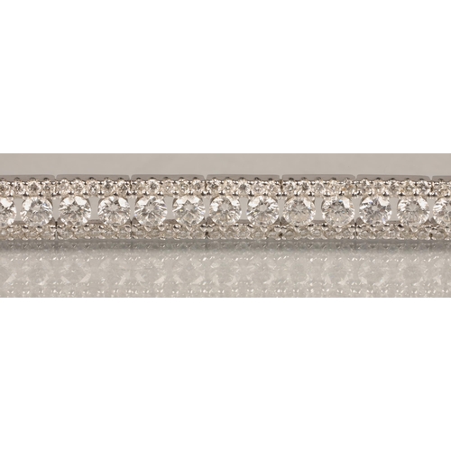 73 - Ladies 18k white gold diamond tennis bracelet, 56 small brilliant cut diamonds with a row of smaller... 