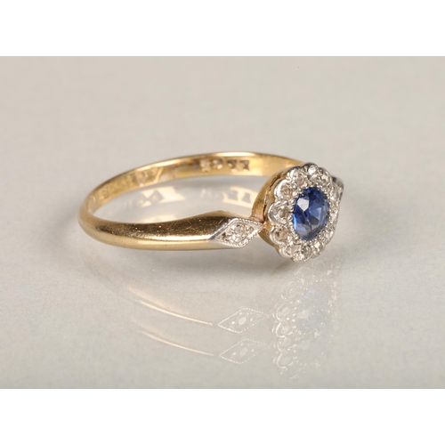 139 - An Art Deco period sapphire and diamond daisy cluster ring, the central round cut sapphire set betwe... 