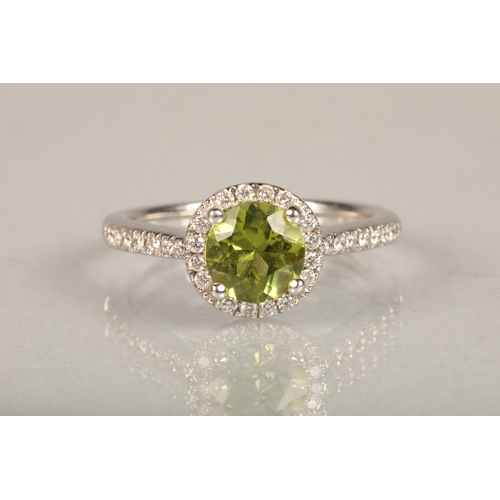 146 - 18ct white gold peridot and diamond ring, the 1.5ct brilliant cut peridot framed with a halo of smal... 