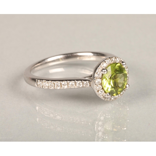 146 - 18ct white gold peridot and diamond ring, the 1.5ct brilliant cut peridot framed with a halo of smal... 