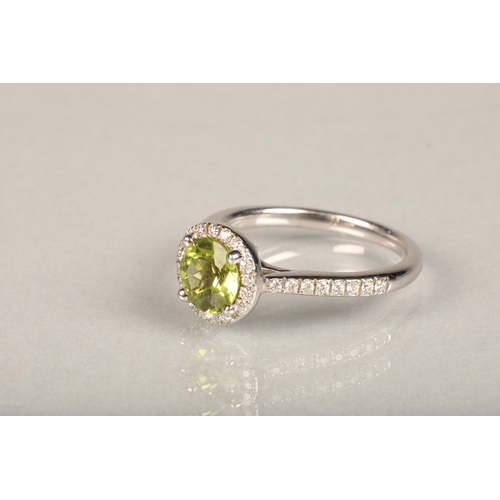 146 - 18ct white gold peridot and diamond ring, the 1.5ct brilliant cut peridot framed with a halo of smal... 