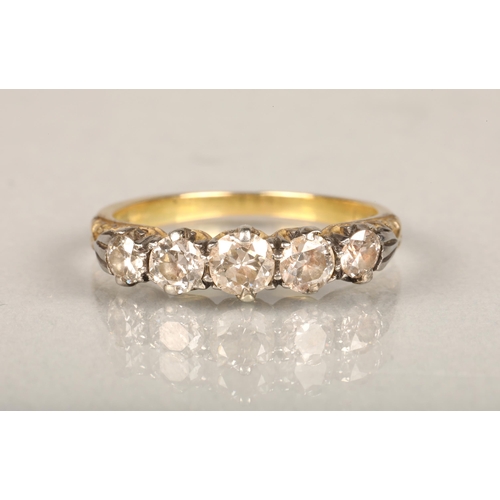 149 - 18ct gold and five stone diamond ring, the graduating diamonds set on a white gold scrolled mount le... 