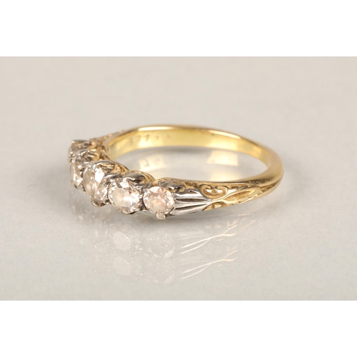 149 - 18ct gold and five stone diamond ring, the graduating diamonds set on a white gold scrolled mount le... 