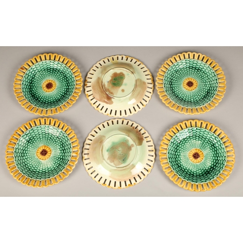 42 - Seven piece Wedgwood majolica fruit set, with green lustre weave effect with yellow pierced border.