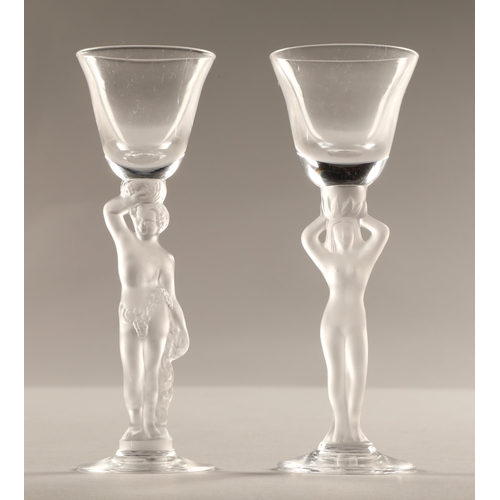 234 - Pair of glasses with frosted figure stems, 15cm high.