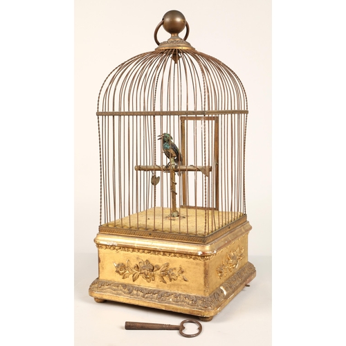 279 - A 19th century mechanical singing bird in a cage, mounted on a gilded base, 55cm high.