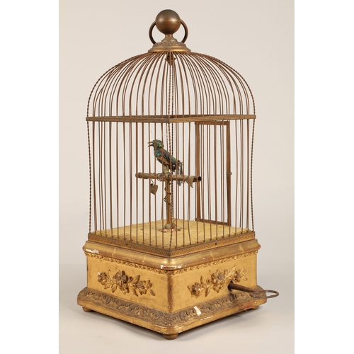 279 - A 19th century mechanical singing bird in a cage, mounted on a gilded base, 55cm high.