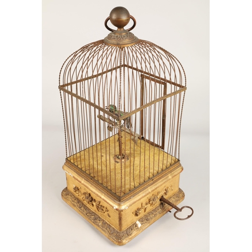 279 - A 19th century mechanical singing bird in a cage, mounted on a gilded base, 55cm high.