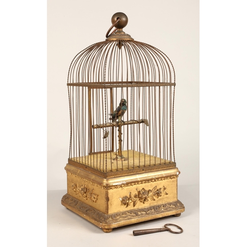 279 - A 19th century mechanical singing bird in a cage, mounted on a gilded base, 55cm high.