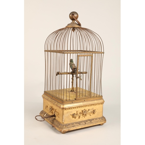 279 - A 19th century mechanical singing bird in a cage, mounted on a gilded base, 55cm high.