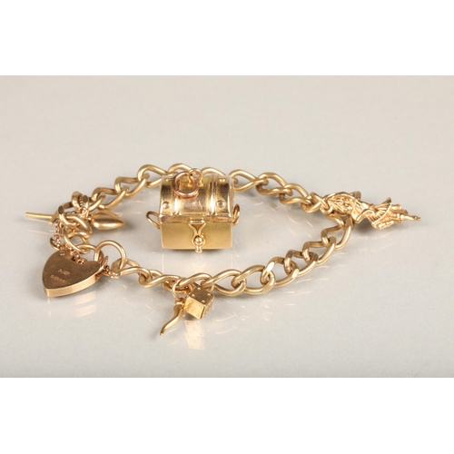 177 - 9ct gold curb link charm bracelet with charms including treasure chest, dice, etc. with heart shaped... 