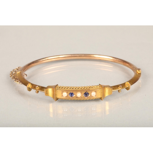 185 - Victorian 9ct gold bangle set with sapphire and seed pearls, applied '9ct' lozenge to the reverse, 7... 