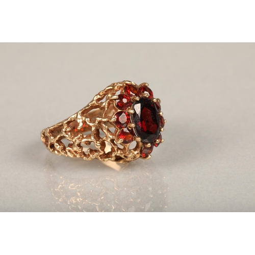 210 - c1970s modernist 9ct gold and garnet cluster ring, the central and surrounding garnet cluster set on... 