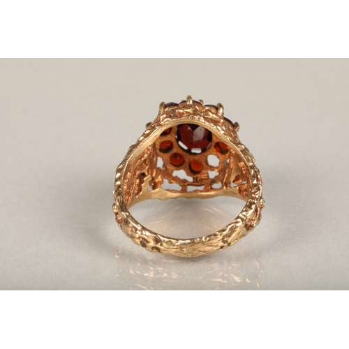 210 - c1970s modernist 9ct gold and garnet cluster ring, the central and surrounding garnet cluster set on... 