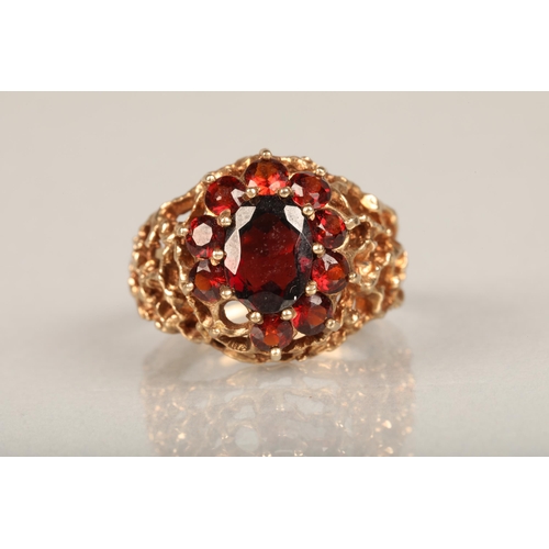 210 - c1970s modernist 9ct gold and garnet cluster ring, the central and surrounding garnet cluster set on... 