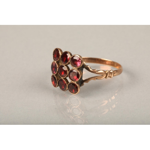 235 - Edwardian garnet and yellow metal ring, the nine round cut garnets in grid shape on split shoulders ... 