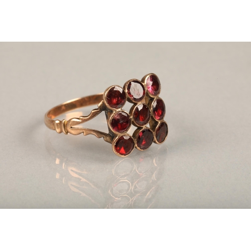 235 - Edwardian garnet and yellow metal ring, the nine round cut garnets in grid shape on split shoulders ... 