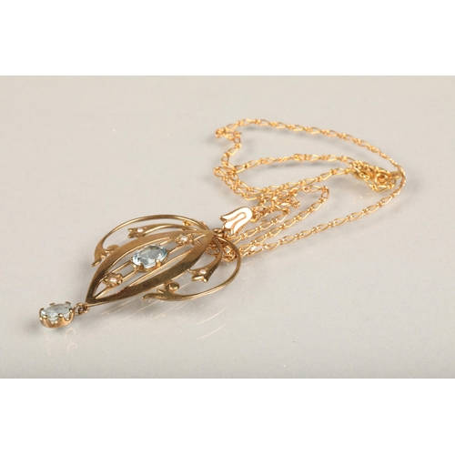 242 - Edwardian Art Nouveau 9ct gold and aquamarine lavaliere pendant, the open work scrolled gold frame a... 