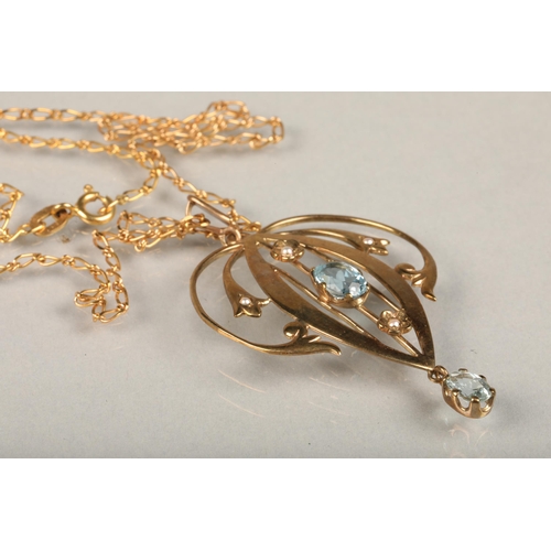 242 - Edwardian Art Nouveau 9ct gold and aquamarine lavaliere pendant, the open work scrolled gold frame a... 