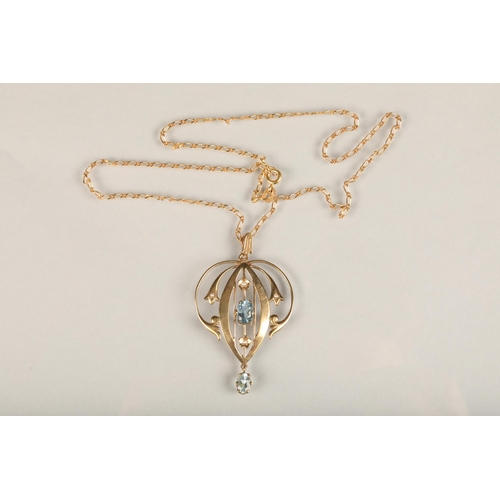 242 - Edwardian Art Nouveau 9ct gold and aquamarine lavaliere pendant, the open work scrolled gold frame a... 