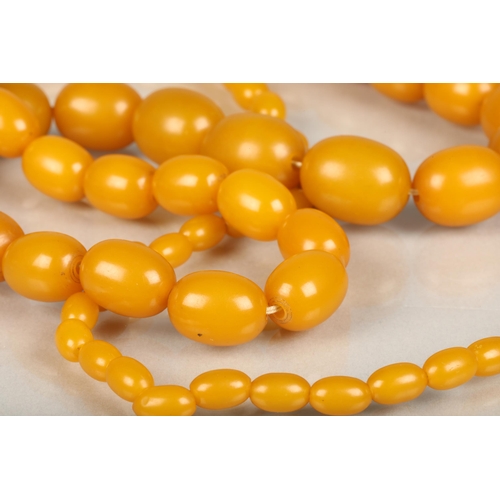 244 - Egg yolk amber or Bakelite beaded necklace, total L99cm, 69g.