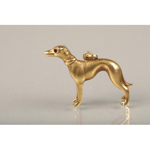 246 - 14ct gold greyhound pendant, the realistically modelled pendant set with faceted ruby eyes, L2.7cm, ... 