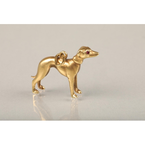 246 - 14ct gold greyhound pendant, the realistically modelled pendant set with faceted ruby eyes, L2.7cm, ... 