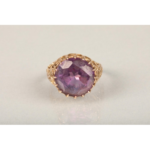 248 - Yellow gold and large amethyst ring, the round cut amethyst claw set on a repeating scroll pattern o... 