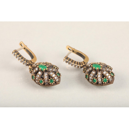 250 - Pair of Indian emerald and white stone earrings, the stones grid set in a burst formation on a yello... 