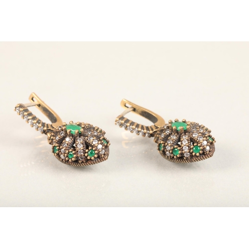 250 - Pair of Indian emerald and white stone earrings, the stones grid set in a burst formation on a yello... 