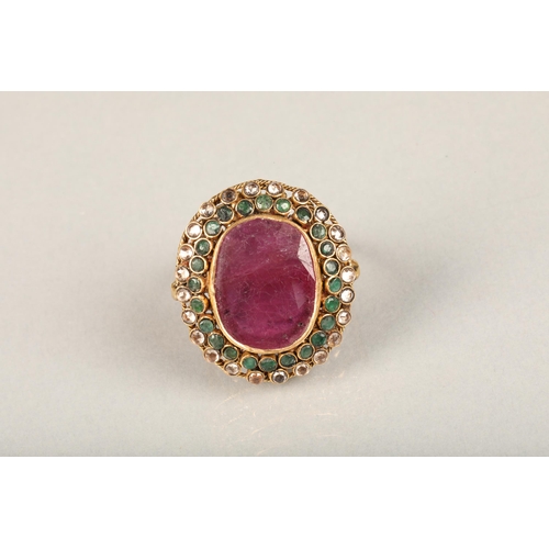 252 - Indian ruby, emerald and white stone cluster cocktail ring (tests as gold), the large oval facet cut... 