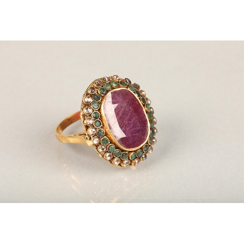 252 - Indian ruby, emerald and white stone cluster cocktail ring (tests as gold), the large oval facet cut... 