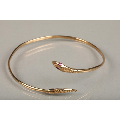 253 - 9ct gold filled snake bangle, the snake head with pink gem set eyes, internal W6.5cm, gross 4.4g.