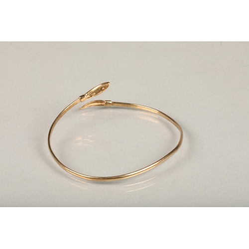 253 - 9ct gold filled snake bangle, the snake head with pink gem set eyes, internal W6.5cm, gross 4.4g.