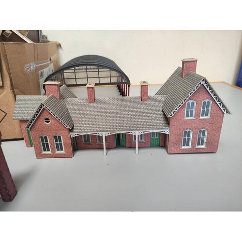 266 - Two boxes of model railway buildings and track components to include a factory, glass station roof e... 